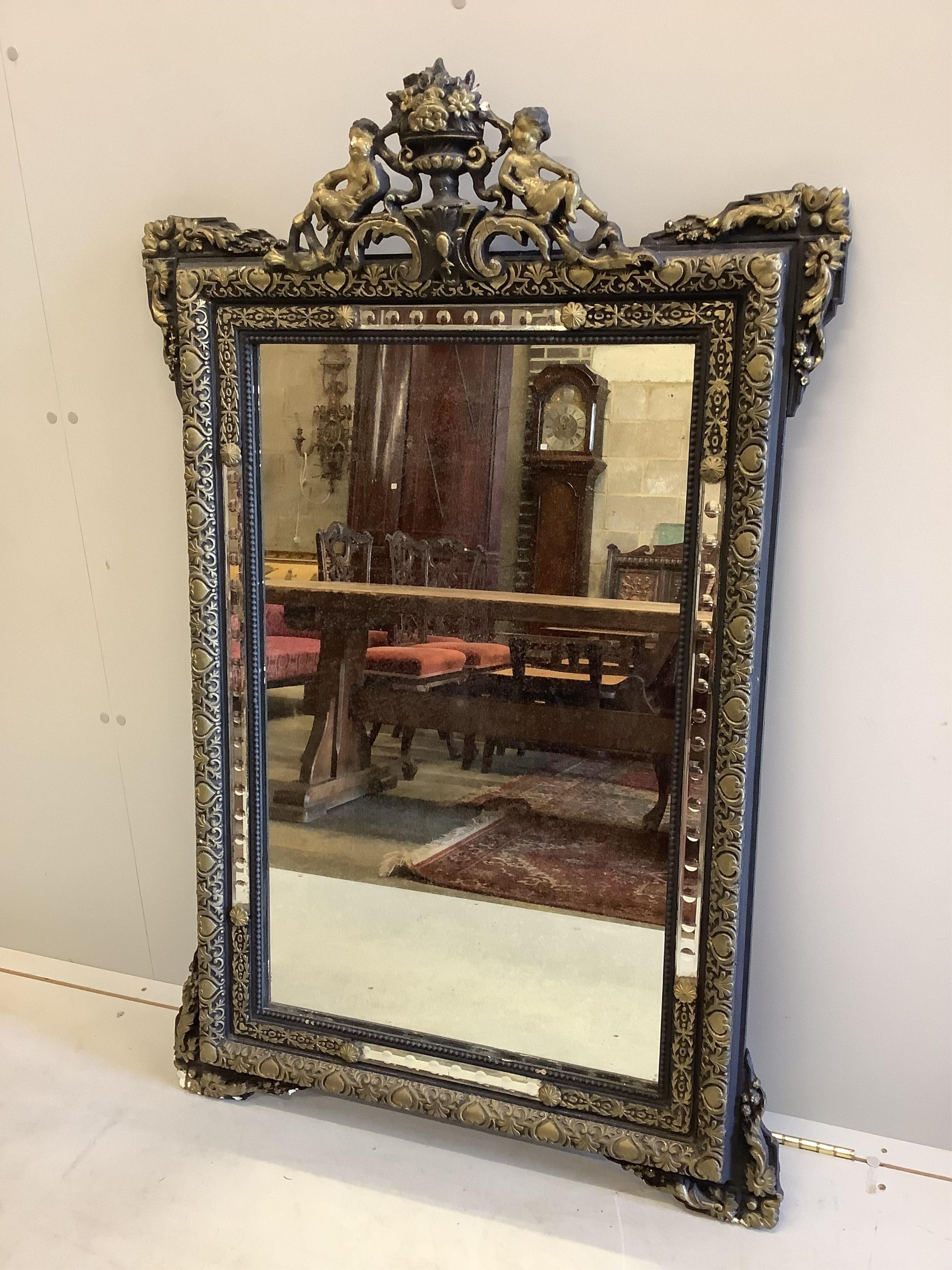 A French decorative wall mirror with cherub motifs, (later painted), width 81cm, height 127cm. Condition - poor